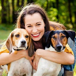 Woman holding two dogs