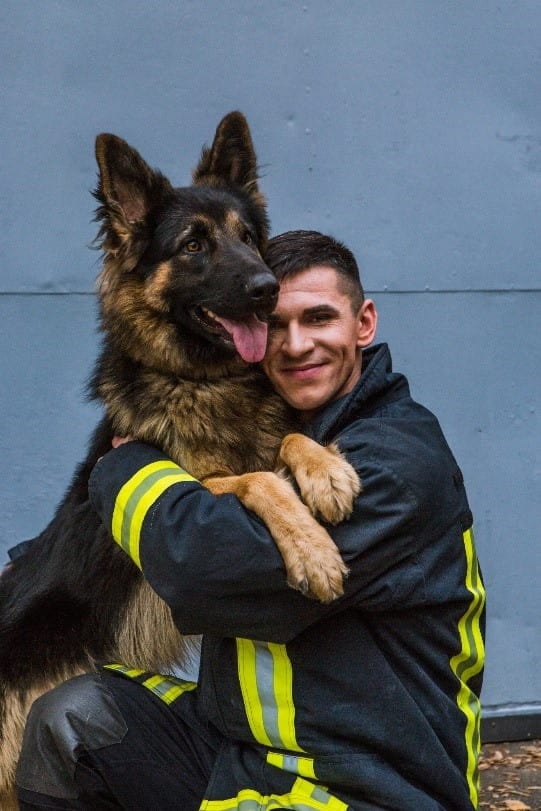Fireman and dog Fireman and dog hugging each other